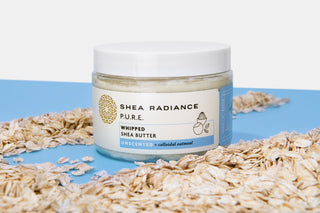 Shea Radiance Whipped Shea Butter tub on a table covered with oats