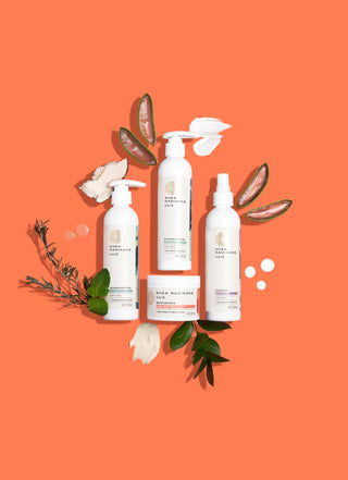 Shea Radiance Hair Care products collection on an orange background surrounded by leaves, aloe vera crystals and shea butter