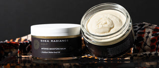 Two jars of Shea Radiance Gold Intense Moisture Balm on a dark background