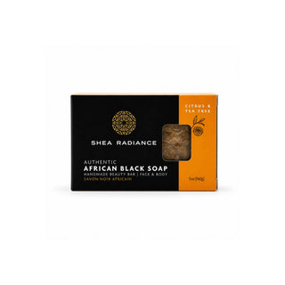 Shea Radiance Authentic African Black Soap in Citrus & Tea Tree scent, featuring a black and orange design with a clear window showing the soap inside.
