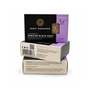 Three stacked lavender bars of Shea Radiance Authentic African Black Soap on a clean white background. The top bar is the main product display, showing its black and blue packaging with a clear window revealing the dark brown soap inside.