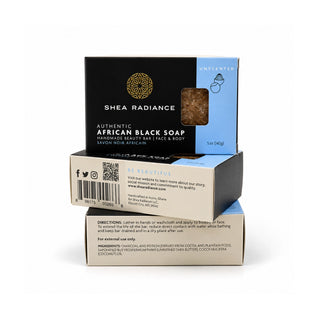Three stacked unscented bars of Shea Radiance Authentic African Black Soap on a clean white background. The top bar is the main product display, showing its black and blue packaging with a clear window revealing the dark brown soap inside.