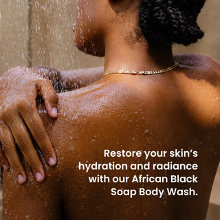A close-up lifestyle shot of a woman with dark curly hair washing her back under running water, wearing a gold chain necklace. White text on the right reads, 'Restore your skin's hydration and radiance with our African Black Soap Body Wash.