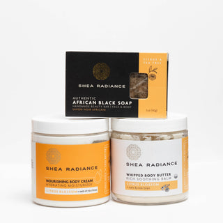 Shea Radiance citrus skincare products including bar of soap, nourishing cream jar, and whipped butter jar on a white background