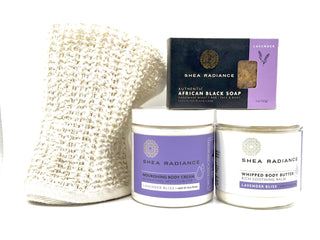 Shea Radiance lavender body care moisture regimen including a soap bar, nourishing cream, whipped butter, and sisal cloth on a white background