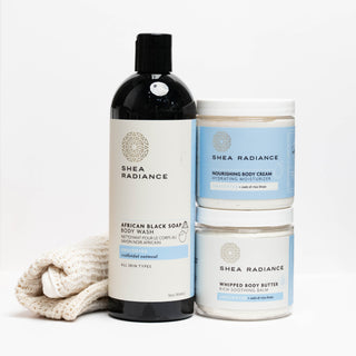 Shea Radiance body care products including a body wash bottle, nourishing cream jar, whipped body butter jar, and sisal cloth on a white background.