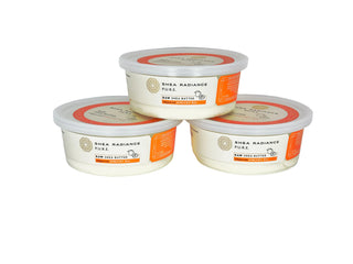 Three containers of apricot small Shea Radiance raw shea butter on a white background
