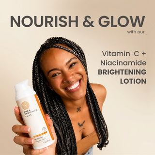 Woman smiling holding a Brightening Body Lotion