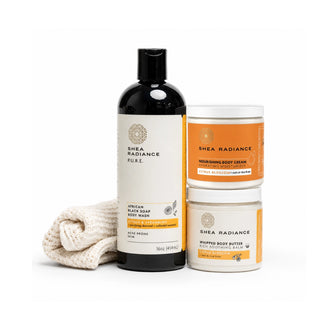 Shea Radiance citrus skincare products including a body wash, nourishing cream, whipped butter and sisal cloth on a white background