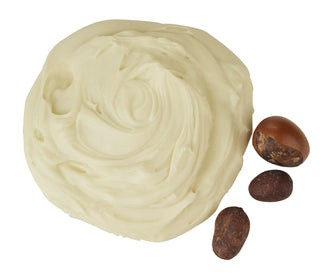 White soap bar with three brown nuts on a white background